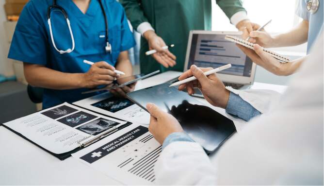 Nurses at a desk going over notes